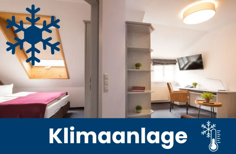 Blick in ein Schlafzimmer und auf einen Arbeitsbereich mit Hinweis auf Klimaanlage